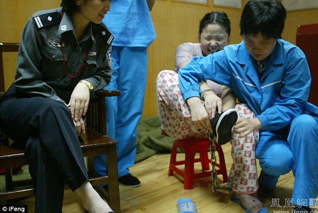 Ms Xiuling smiles as she squeezes into the new shoes she will wear for the execution 