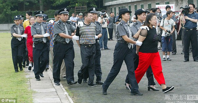 Ms Xiuling is at the front of the line as 16 other convicts are walked in front of members of the public to the execution ground 