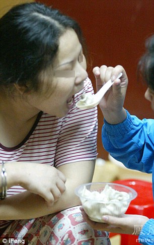 Another female prisoner feeds Ms Xiuling dumplings for a late-night snack